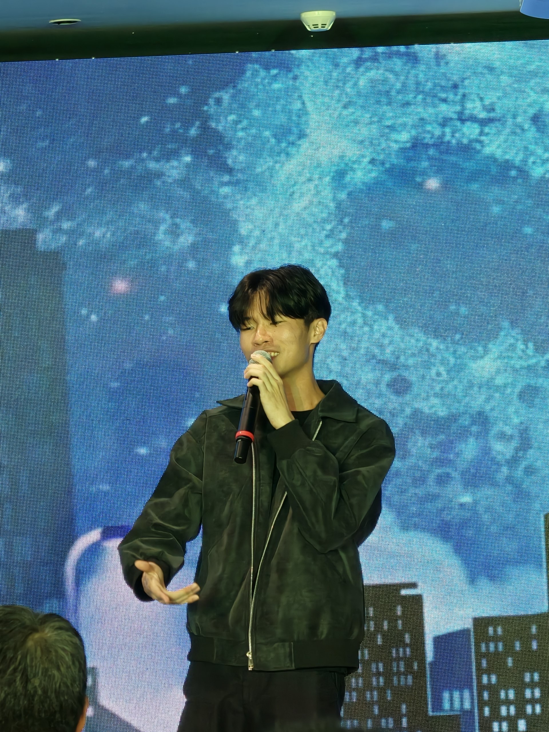 Junoz on stage with LED backdrop